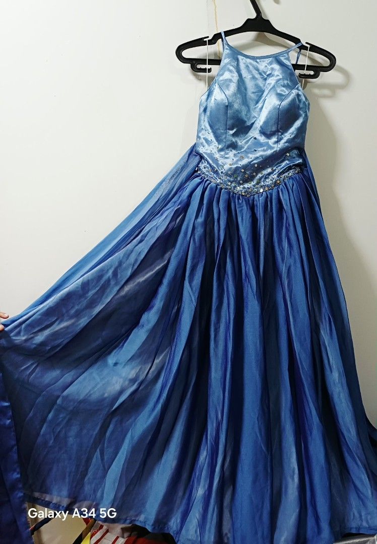 Blue Halter Neck Formal Dress (Category: Dresses) located in Makati City. Submitted by nnn28 (Listing ID 1402859456, Image 2). Description: - Elegant blue formal dress - Halter neck design - Fitted bodice with sequin embellishments - Flowing skirt - Bow detail at the back - Ideal for special occasions.