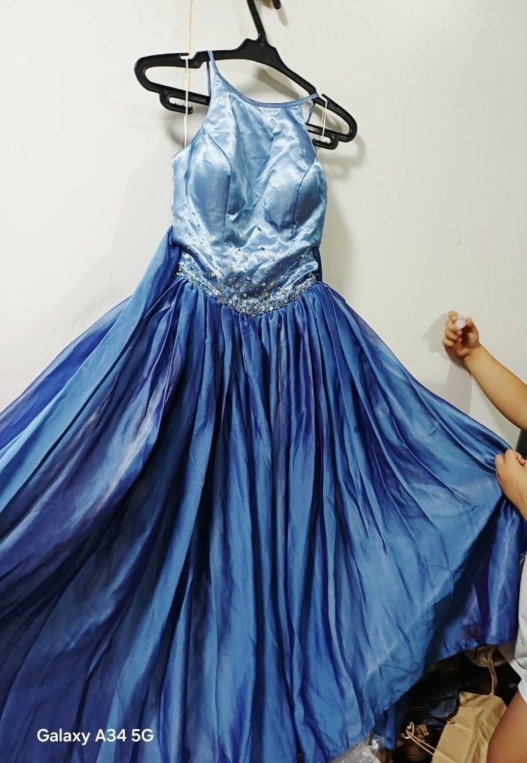 Blue Halter Neck Formal Dress (Category: Dresses) located in Makati City. Submitted by nnn28 (Listing ID 1402859456, Image 3). Description: - Elegant blue formal dress - Halter neck design - Fitted bodice with sequin embellishments - Flowing skirt - Bow detail at the back - Ideal for special occasions.