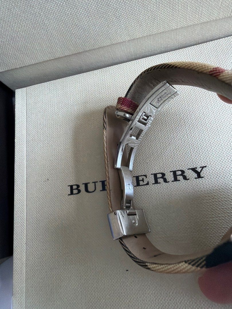 Burberry Rectangular Watch (Category: Watches) located in Kuala Lumpur. Submitted by epique_ico (Listing ID 1402909423, Image 2). Description: - Authentic Burberry watch - Black rectangular dial - Beige and brown plaid strap - Silver-tone case - Clasp closure - Includes original box - Includes warranty booklet - Includes original packaging - Burberry logo visible.