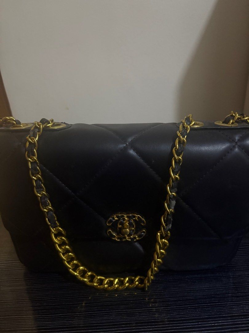 Chanel Black Quilted Shoulder Bag (Category: Luxury Bags & Wallets) located in Rizal. Submitted by declutterlikemarie (Listing ID 1402957034, Image 1). Description: - Black quilted shoulder bag - Gold-tone chain strap - Iconic interlocking CC logo - Red fabric lining - Interior pocket - Shows wear and tear on exterior and lining.