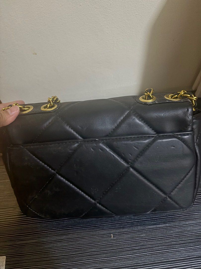Chanel Black Quilted Shoulder Bag (Category: Luxury Bags & Wallets) located in Rizal. Submitted by declutterlikemarie (Listing ID 1402957034, Image 2). Description: - Black quilted shoulder bag - Gold-tone chain strap - Iconic interlocking CC logo - Red fabric lining - Interior pocket - Shows wear and tear on exterior and lining.
