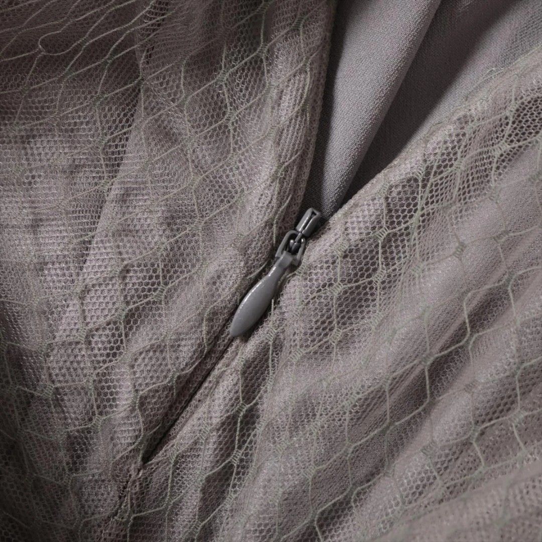 Christian Dior Tulle Skirt (Category: Luxury Apparel) located in San Jose. Submitted by cheapest_thrill_closet (Listing ID 1402983167, Image 3). Description: Christian Dior Tulle Skirt Brand & Origin: Christian Dior Paris, Made in Italy. Color & Fabric: The skirt is a sophisticated dusty olive green or khaki-grey color. It is made of multiple layers of fine tulle/netting (100% Polyamide) with a layer of silk lining ("Doublure - Lining: 100% Soie 