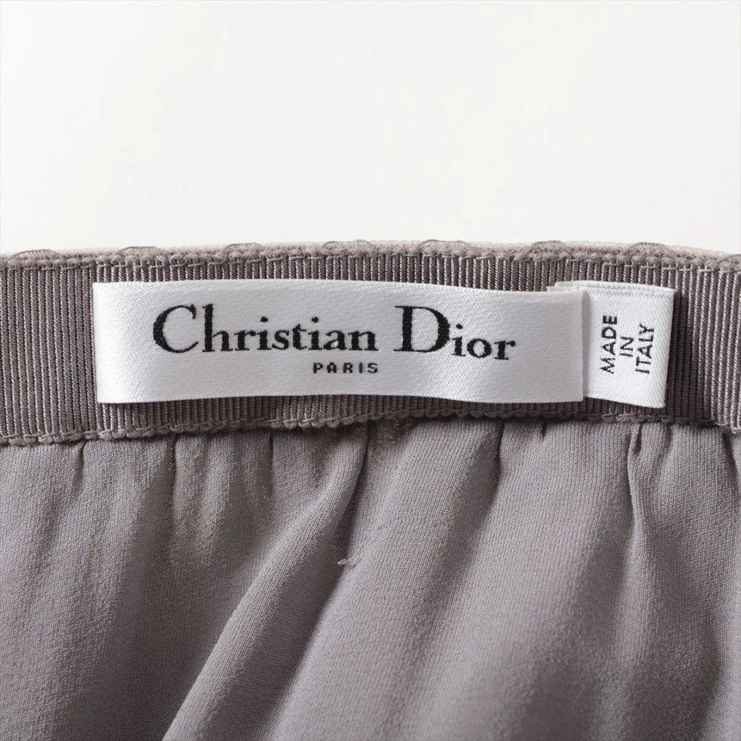 Christian Dior Tulle Skirt (Category: Luxury Apparel) located in San Jose. Submitted by cheapest_thrill_closet (Listing ID 1402983167, Image 2). Description: Christian Dior Tulle Skirt Brand & Origin: Christian Dior Paris, Made in Italy. Color & Fabric: The skirt is a sophisticated dusty olive green or khaki-grey color. It is made of multiple layers of fine tulle/netting (100% Polyamide) with a layer of silk lining ("Doublure - Lining: 100% Soie 