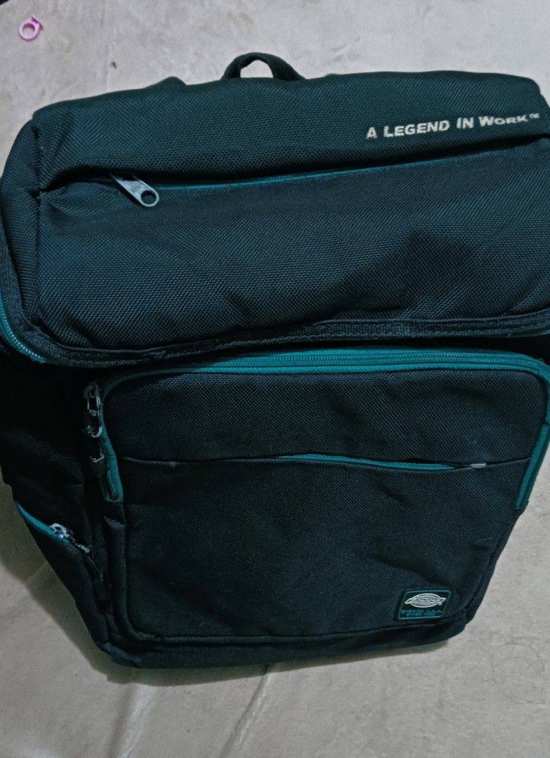 Dickies Backpack (Category: Backpacks) located in Laoag. Submitted by catrnzjb153008 (Listing ID 1402996191, Image 3). Description: - Dickies backpack - Multiple compartments - Laptop sleeve - Padded shoulder straps - Top handle - Dickies logo detail - Teal zipper accents.