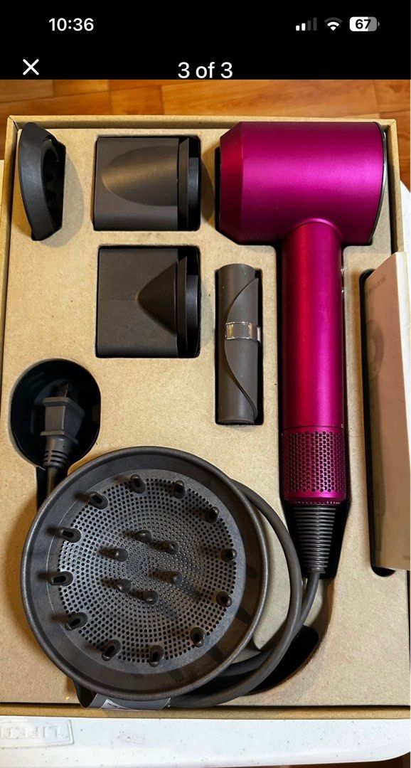 Dyson Supersonic Hair Dryer (Category: Hair) located in Quezon City. Submitted by the_happy_mess_shop (Listing ID 1402971885, Image 3). Description: - Dyson Supersonic hair dryer - Vibrant magenta color - Includes round brush, comb, diffuser, and styling attachments - Designed for fast drying and heat protection - Comes with original box, user manual and accessories.
