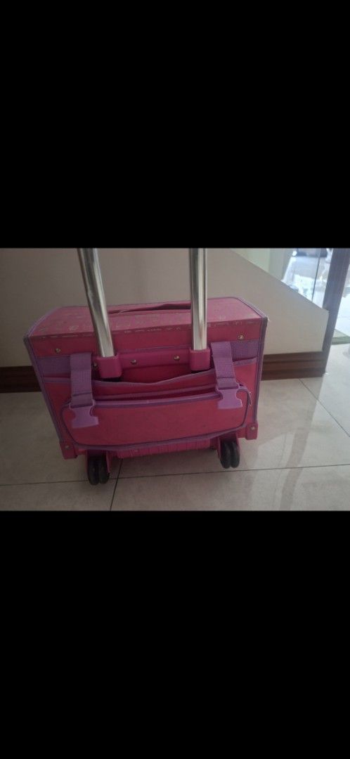 Hello Kitty Rolling Luggage (Category: Luggage) located in Manila. Submitted by kitto222 (Listing ID 1402849081, Image 2). Description: - Pink Kitty rolling luggage - Retractable handle and wheels for easy transport - Main compartment for storage - Front pocket with Kitty design - Top handle for carrying - Side pocket for extra storage - Pink interior with a side pocket.
