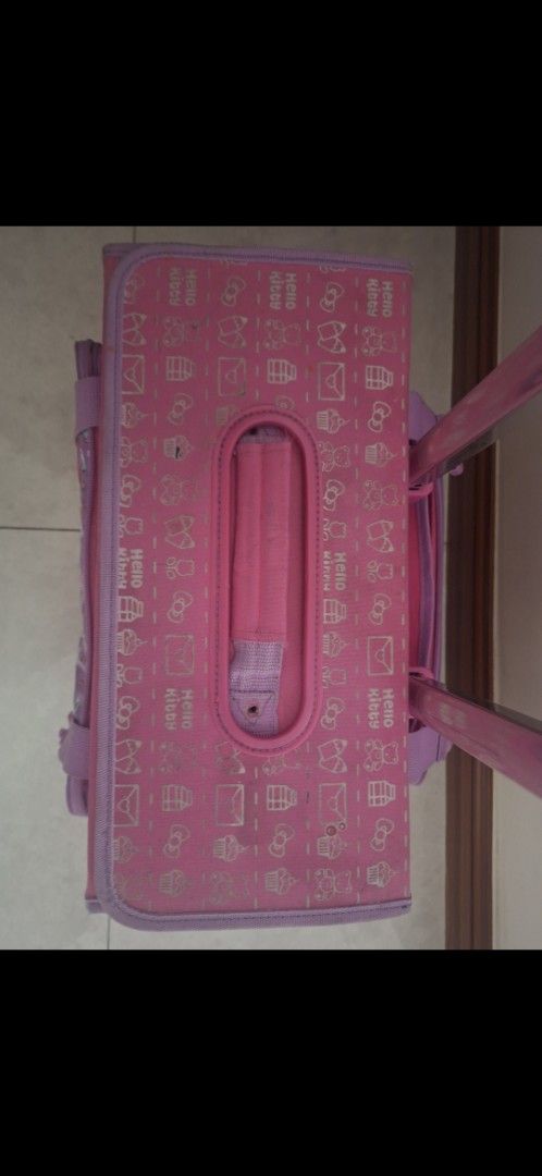 Hello Kitty Rolling Luggage (Category: Luggage) located in Manila. Submitted by kitto222 (Listing ID 1402849081, Image 3). Description: - Pink Kitty rolling luggage - Retractable handle and wheels for easy transport - Main compartment for storage - Front pocket with Kitty design - Top handle for carrying - Side pocket for extra storage - Pink interior with a side pocket.