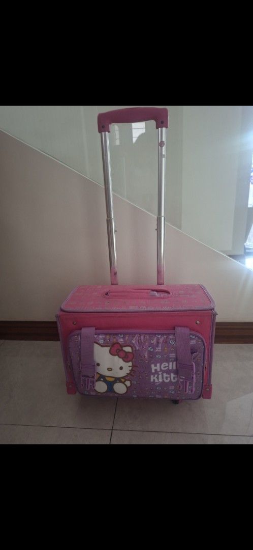 Hello Kitty Rolling Luggage (Category: Luggage) located in Manila. Submitted by kitto222 (Listing ID 1402849081, Image 1). Description: - Pink Kitty rolling luggage - Retractable handle and wheels for easy transport - Main compartment for storage - Front pocket with Kitty design - Top handle for carrying - Side pocket for extra storage - Pink interior with a side pocket.