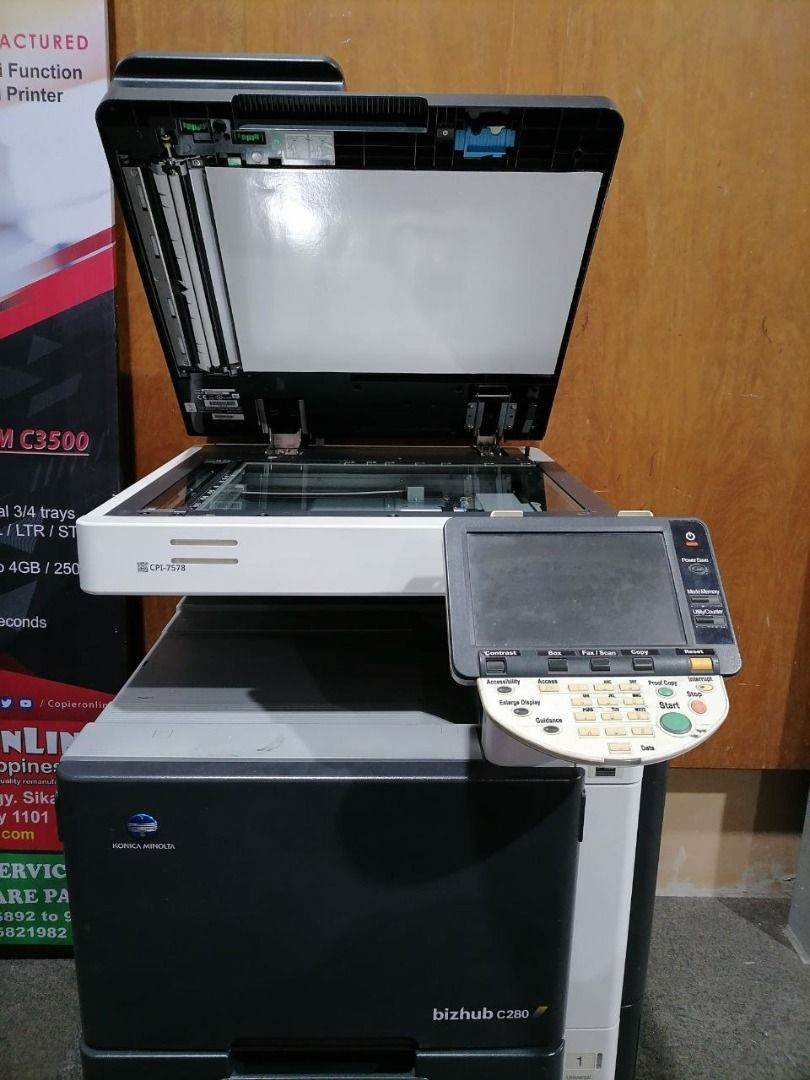 Konica Minolta Bizhub C280 Copier (Category: Printers, Scanners & Copiers) located in Quezon City. Submitted by copieronlineinc (Listing ID 1402868244, Image 3). Description: - Konica Minolta Bizhub C280 color copier - Features a user-friendly control panel and display screen - Equipped with multiple paper trays for efficient printing - Sleek black and white design - Model number clearly visible.