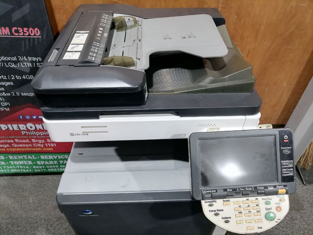 Konica Minolta Bizhub C280 Copier (Category: Printers, Scanners & Copiers) located in Quezon City. Submitted by copieronlineinc (Listing ID 1402868244, Image 2). Description: - Konica Minolta Bizhub C280 color copier - Features a user-friendly control panel and display screen - Equipped with multiple paper trays for efficient printing - Sleek black and white design - Model number clearly visible.