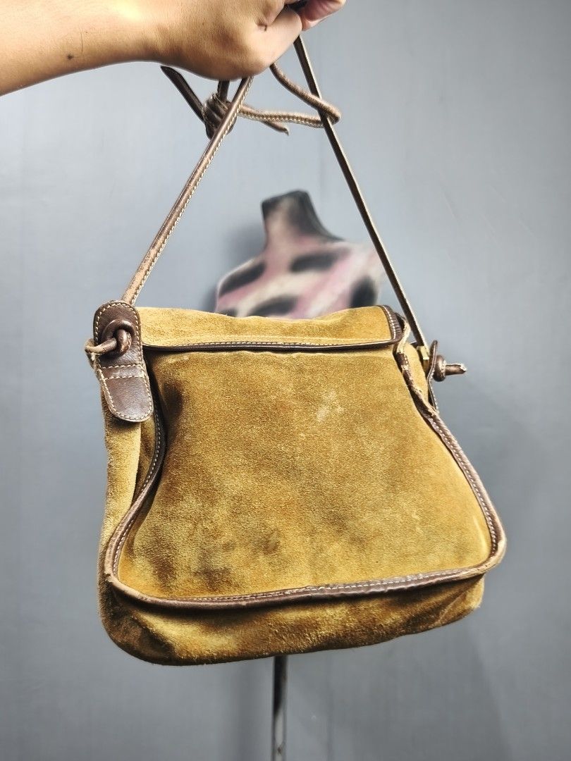 Loewe Suede Shoulder Bag (Category: Luxury Bags & Wallets) located in Dasmarinas. Submitted by goldengem_e4eb01 (Listing ID 1402899360, Image 3). Description: - Authentic Loewe shoulder bag - Suede exterior with leather trim - Flap closure with embossed Loewe logo - Gold-tone lock with Loewe logo - Zippered main compartment - Interior pocket - Includes shoulder strap.