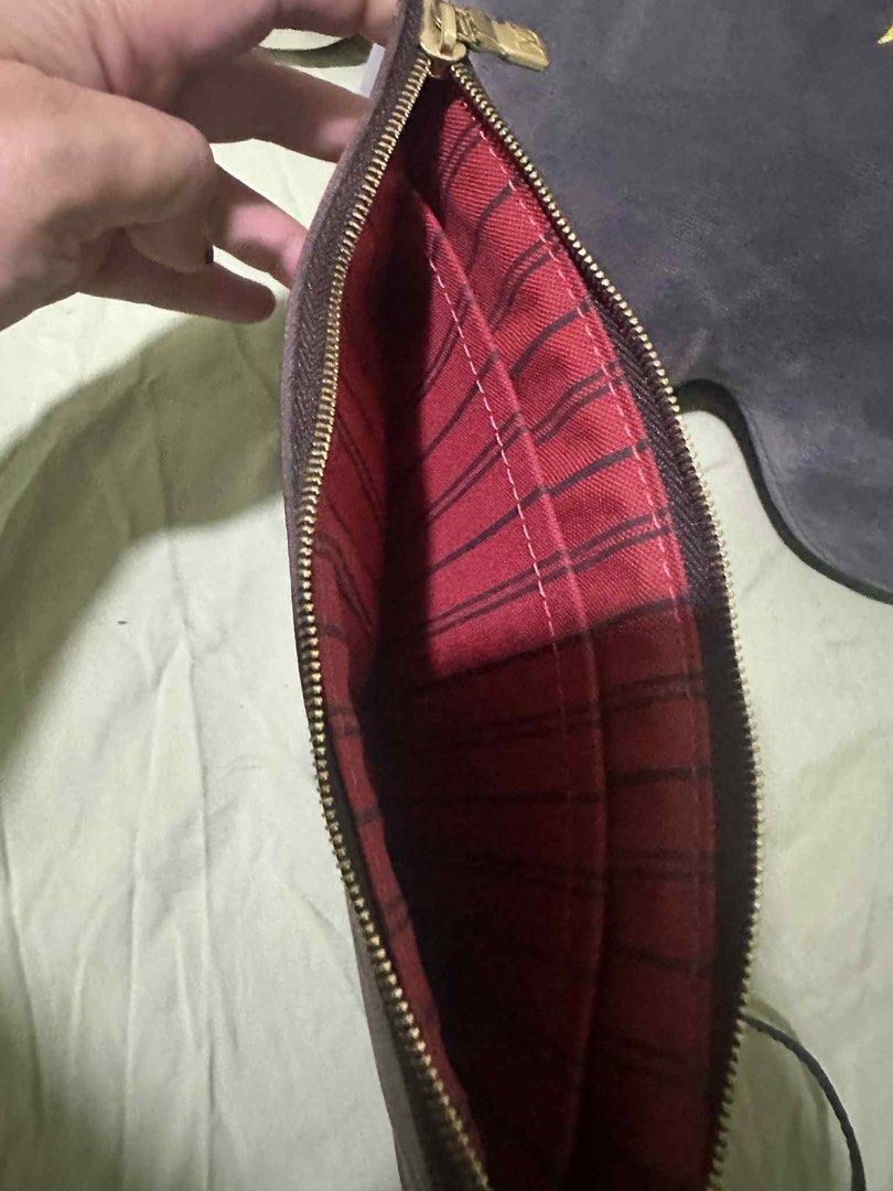 Louis Vuitton 2017 Damier Ebene Pochette Clutch (Category: Luxury Bags & Wallets) located in Manila. Submitted by numee (Listing ID 1402870783, Image 3). Description: - Authentic Louis Vuitton Pochette Clutch - Iconic Damier Ebene canvas - Secure zip closure - Interior lined with red fabric - Features a wrist strap with gold-tone clasp - Made in Spain Barely used, like new. Price is negotiable though lowballing will not be accepted nor entertaine