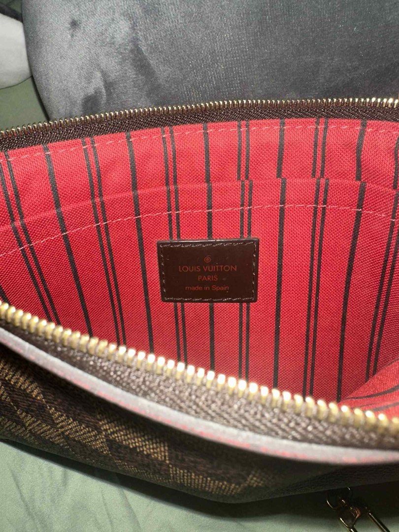 Louis Vuitton 2017 Damier Ebene Pochette Clutch (Category: Luxury Bags & Wallets) located in Manila. Submitted by numee (Listing ID 1402870783, Image 2). Description: - Authentic Louis Vuitton Pochette Clutch - Iconic Damier Ebene canvas - Secure zip closure - Interior lined with red fabric - Features a wrist strap with gold-tone clasp - Made in Spain Barely used, like new. Price is negotiable though lowballing will not be accepted nor entertaine