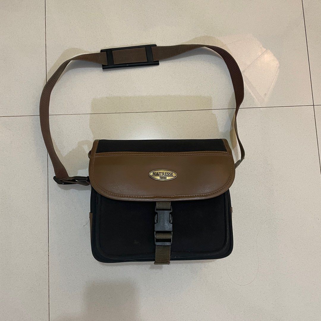Maitresse Tokyo Brown & Black Shoulder Bag (Category: Camera Bags & Carriers) located in Cagayan de Oro. Submitted by suta.__.ph (Listing ID 1403029075, Image 1). Description: Classic vintage-style Maitresse Tokyo shoulder bag in brown and black combination. Features a secure buckle closure, adjustable strap with padded shoulder grip, and spacious main compartment. Good used condition — with minor signs of wear consistent with age. Perfect for ca