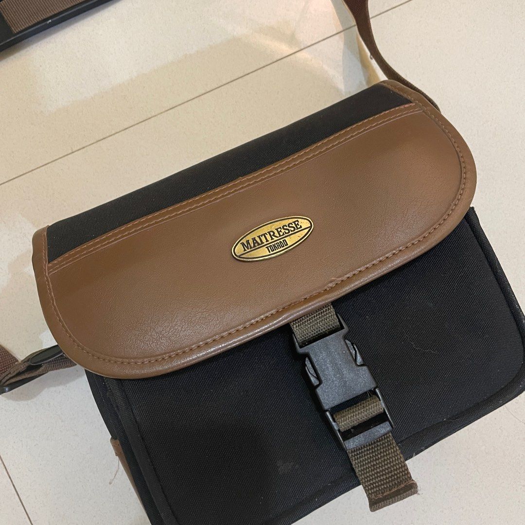 Maitresse Tokyo Brown & Black Shoulder Bag (Category: Camera Bags & Carriers) located in Cagayan de Oro. Submitted by suta.__.ph (Listing ID 1403029075, Image 2). Description: Classic vintage-style Maitresse Tokyo shoulder bag in brown and black combination. Features a secure buckle closure, adjustable strap with padded shoulder grip, and spacious main compartment. Good used condition — with minor signs of wear consistent with age. Perfect for ca