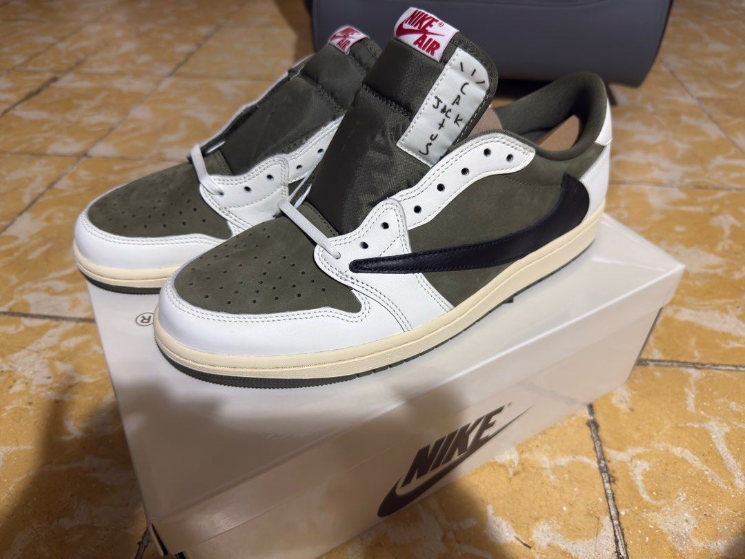 Nike Air Jordan 1 Low Travis Scott (Category: Sneakers) located in Makati City. Submitted by martinoloco (Listing ID 1402893261, Image 3). Description: - Nike Air Jordan 1 Low Travis Scott sneakers - Size: US 11 - Color: White and olive green - Iconic reverse swoosh design - Features Travis Scott logo on the heel - Unused with complete pack - Guaranteed authentic and collector’s item.