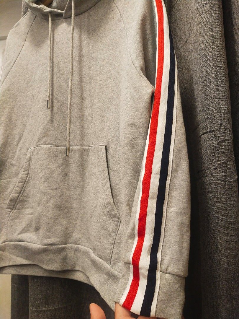 Thom Browne New York Hoodie (Category: Coats, Jackets and Outerwear) located in Quezon City. Submitted by markythegrappler17 (Listing ID 1402937977, Image 2). Description: Thom Browne -Size 2 -Dimes 20W/26L -Excellent Condition -9/20 Condition -Color grey -washable stain on side -Stripe design by Thom Browne on side .