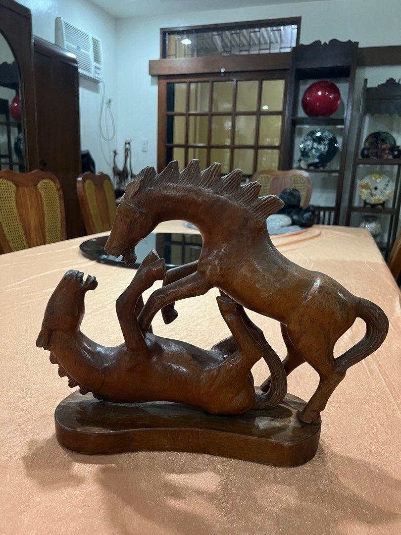 Wooden Horse Sculpture (Category: Other Home Decor) located in Paranaque City. Submitted by mariafernandez917 (Listing ID 1402921132, Image 1). Description: Elegant hand-carved wooden sculpture depicting two horses in motion — a unique and expressive piece perfect for rustic or vintage interiors. Crafted from solid hardwood with fine detailing and smooth polish. A beautiful collectible or statement décor piece. Material: Solid wood (likely mahoga
