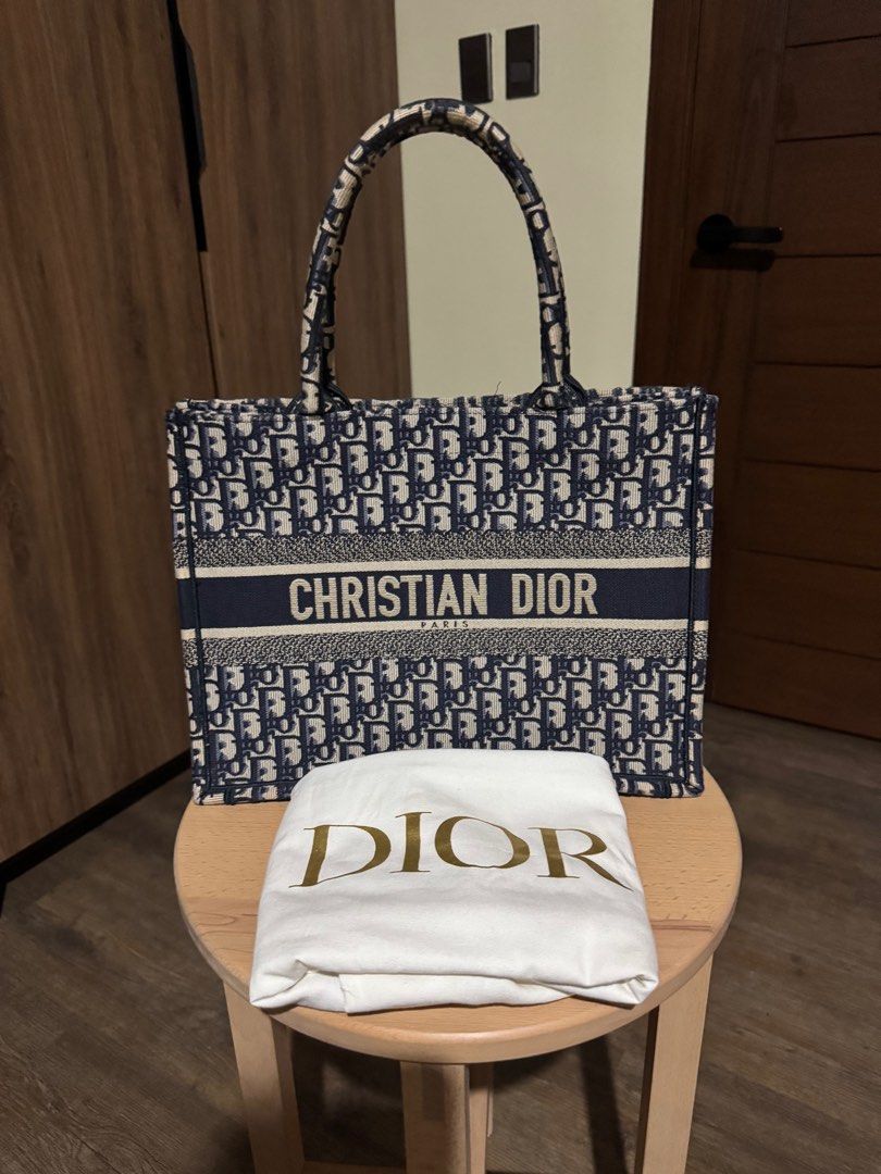 Christian Dior Book Tote Bag Medium (Category: Luxury Bags & Wallets) located in Rizal. Submitted by shopaholicsnook (Listing ID 1403200632, Image 1). Description: - Authentic Christian Dior Book Tote Bag - Navy blue color - Features the iconic Dior Oblique pattern - Includes dust bag - Spacious interior - Sturdy handles - Ideal for everyday use - Stylish and practical accessory.