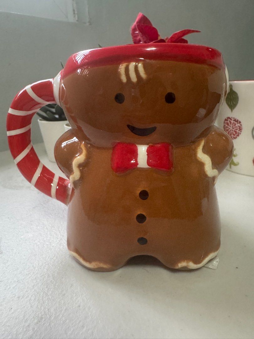 Christmas Gingerbread Mug (Category: Other Kitchenware & Tableware) located in Famy. Submitted by bettyque (Listing ID 1403062614, Image 1). Description: - Christmas Gingerbread Mug - Adorable gingerbread man design - Features a candy cane handle and red bow tie - Perfect for holiday drinks - Meetup locations: Susano Road, Novaliches General Hospital.