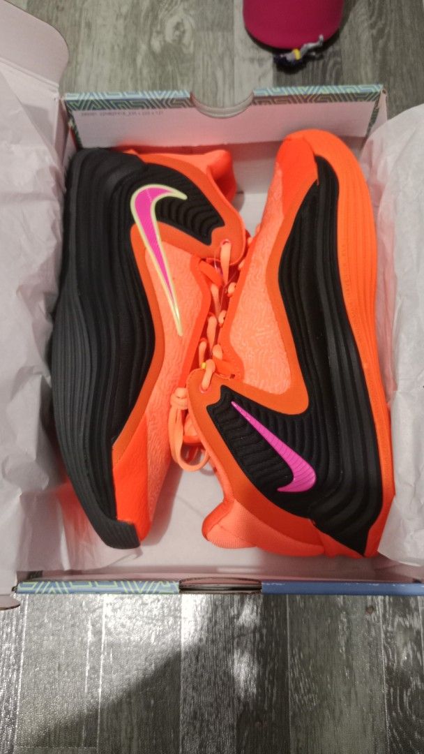 Nike Air Zoom G.T. Cut 2 - Orange (Category: Sneakers) located in Valenzuela. Submitted by jannah528 (Listing ID 1403100416, Image 1). Description: Nike Air Zoom G.T. Cut 2 in vibrant orange and black. Features a pink swoosh and a unique sole design. Includes the original box. Size US 10, UK 9. Made in Vietnam. The shoes have orange laces and a matching orange tongue. The box has a geometric pattern..