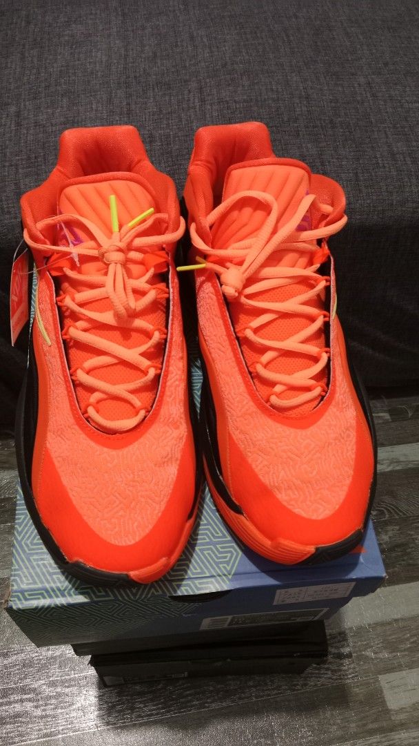 Nike Air Zoom G.T. Cut 2 - Orange (Category: Sneakers) located in Valenzuela. Submitted by jannah528 (Listing ID 1403100416, Image 3). Description: Nike Air Zoom G.T. Cut 2 in vibrant orange and black. Features a pink swoosh and a unique sole design. Includes the original box. Size US 10, UK 9. Made in Vietnam. The shoes have orange laces and a matching orange tongue. The box has a geometric pattern..