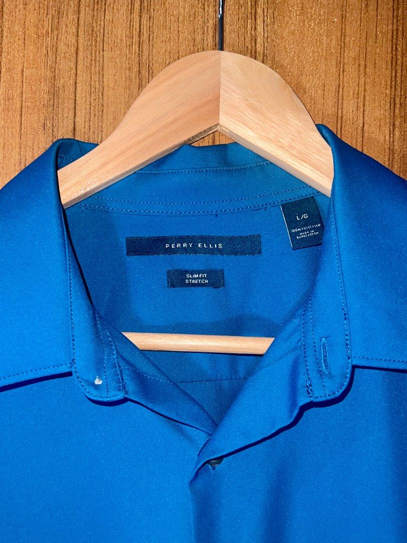 Perry Ellis Slim Fit Stretch Shirt (Category: Tshirts & Polo Shirts ) located in Manila. Submitted by drreeves (Listing ID 1403178381, Image 3). Description: Perry Ellis shirt features a slim fit design and is made of stretch fabric. It has short sleeves and a classic collar. The shirt is a vibrant blue or teal color. It has a button-down closure and a chest pocket. The size is L/G. Never worn; bought for a corpo photoshoot that didn’t happen. Or
