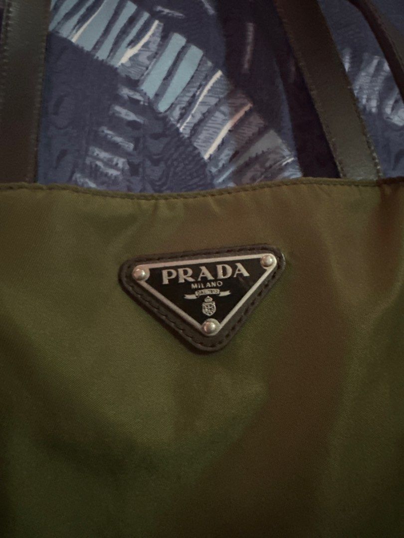 Authentic Prada Nylon Tote Bag (Category: Luxury Bags & Wallets) located in Los Banos. Submitted by bianxster (Listing ID 1403022235, Image 2). Description: - Authentic Prada tote bag - Green nylon material - Brown leather handles - Perfect pangharabas/everyday bag:) - Inclusion: cards and generic dust bag - Has normal wear (some glazing in the handles) though barely noticeable, and still in very good condition - if you’re maselan, this bag is no