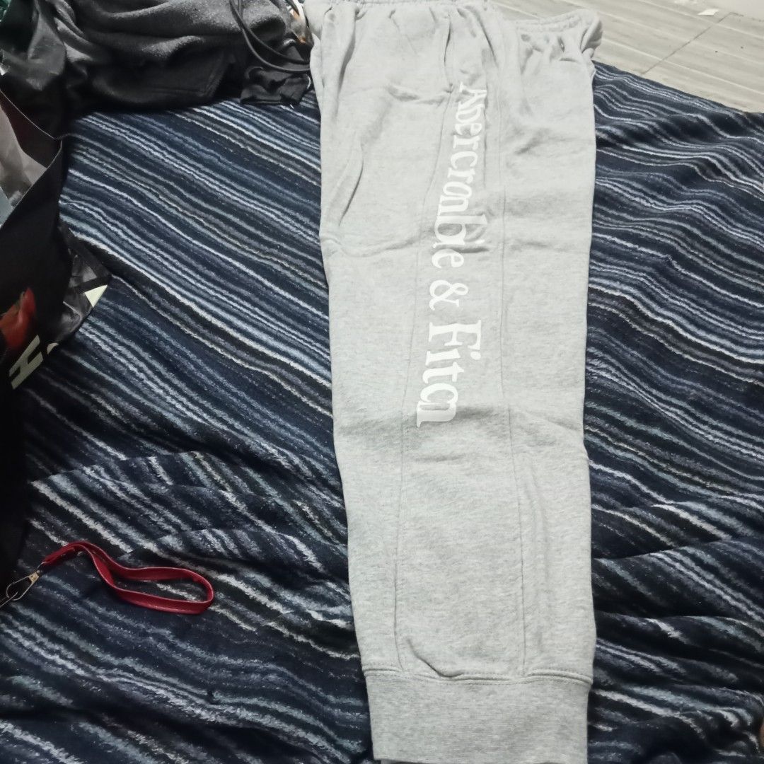 Abercrombie & Fitch XL Sweatpants (Category: Coats, Jackets and Outerwear) located in Bulacan. Submitted by fujikko (Listing ID 1407194635, Image 2). Description: Gray Abercrombie & Fitch sweatpants. Features the brand name printed vertically on the side of the leg. Includes a back pocket and an elastic waistband. Size XL. Made in China. Care instructions include gentle machine wash at 30°C, do not bleach, cool iron, do not dry clean, do not tumb