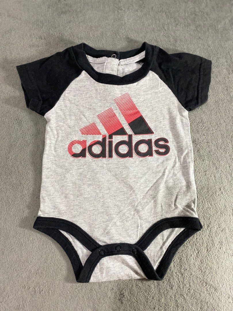 Adidas onesie 3M on tag (Category: Babies & Kids Fashion) located in Binan City. Submitted by _bevalmazora (Listing ID 1407335462, Image 1). Description: - Adidas onesie - Size: 3M - Features the Adidas logo - Color: Gray and black.