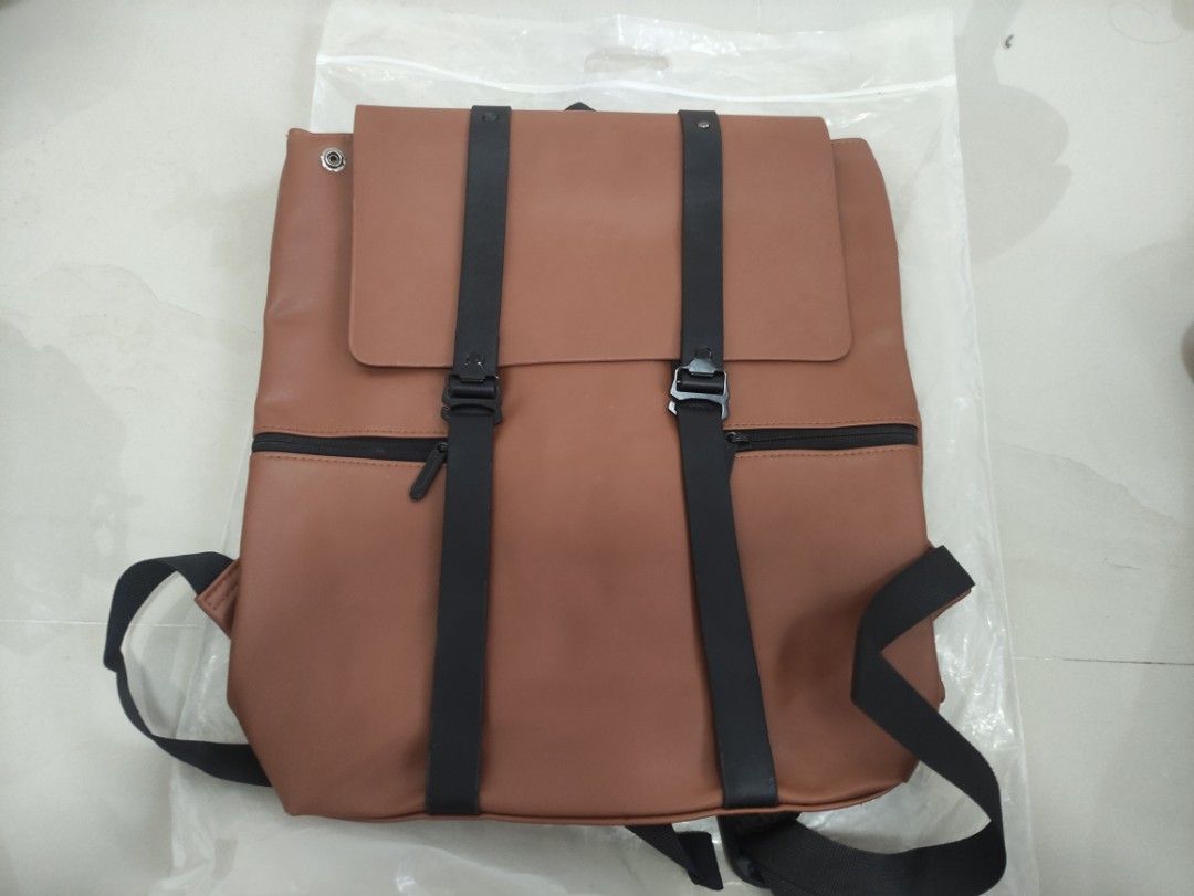 BRAND NEW Korean Brown Backpack with Black Straps (Category: Backpacks) located in Quezon City. Submitted by thetimelessfinds (Listing ID 1407200157, Image 3). Description: Selling my brand new leather backpack. Still in pristine condition. Purchased for office use, but I never got to use it as I was given an office backpack shortly after. In a very excellent, ready-to-use condition. This is a new and unused brown backpack, still sealed in its or