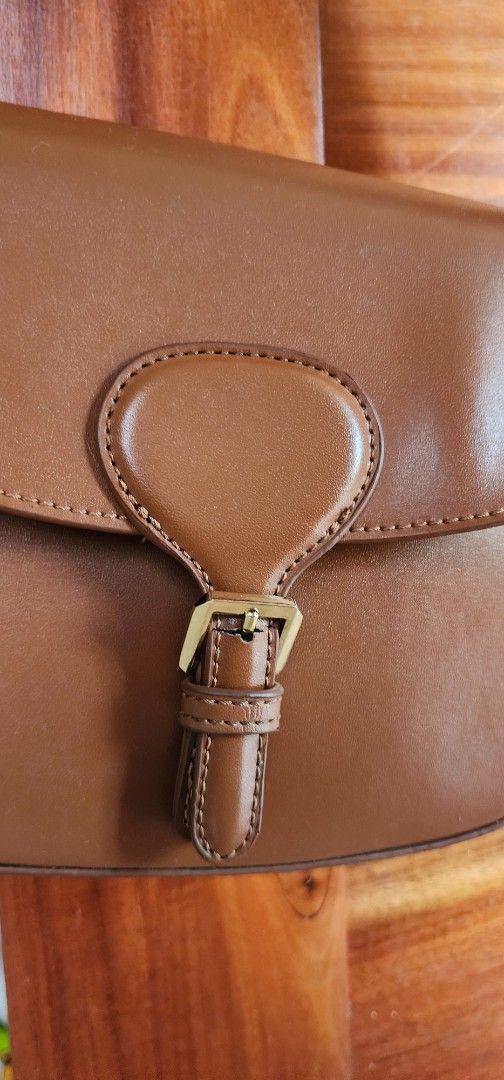Brown Shoulder Bag with Gold Hardware (Category: Luxury Bags & Wallets) located in Manila. Submitted by gingerific (Listing ID 1407204130, Image 2). Description: - Stylish brown shoulder bag - Flap closure with gold-colored hardware - Detachable and adjustable strap - Structured design with buckle detail - Made of smooth, leather-like material - Ideal for everyday or special events.
