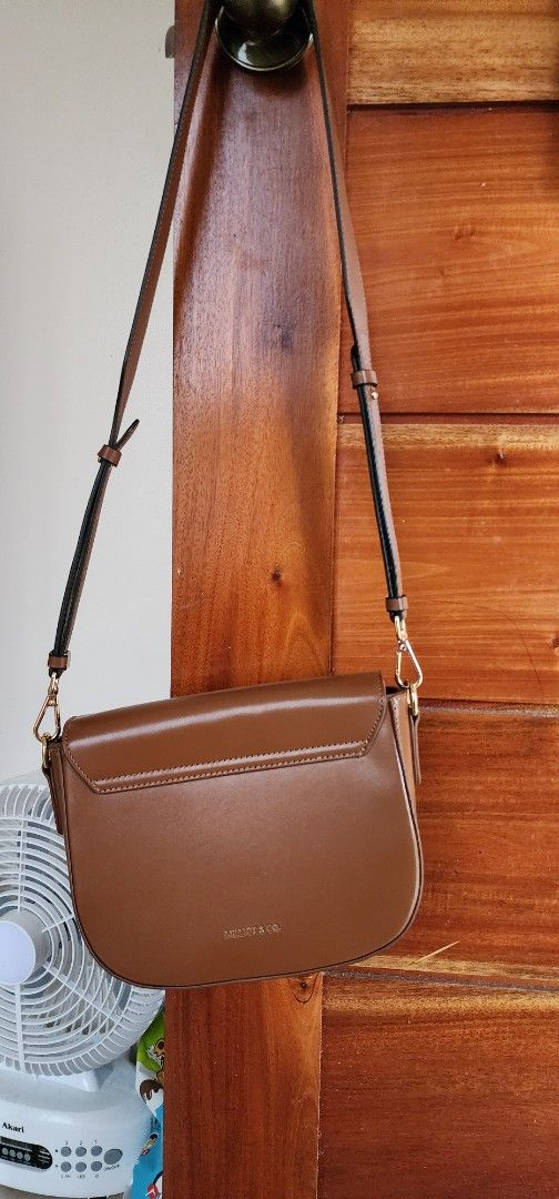 Brown Shoulder Bag with Gold Hardware (Category: Luxury Bags & Wallets) located in Manila. Submitted by gingerific (Listing ID 1407204130, Image 3). Description: - Stylish brown shoulder bag - Flap closure with gold-colored hardware - Detachable and adjustable strap - Structured design with buckle detail - Made of smooth, leather-like material - Ideal for everyday or special events.