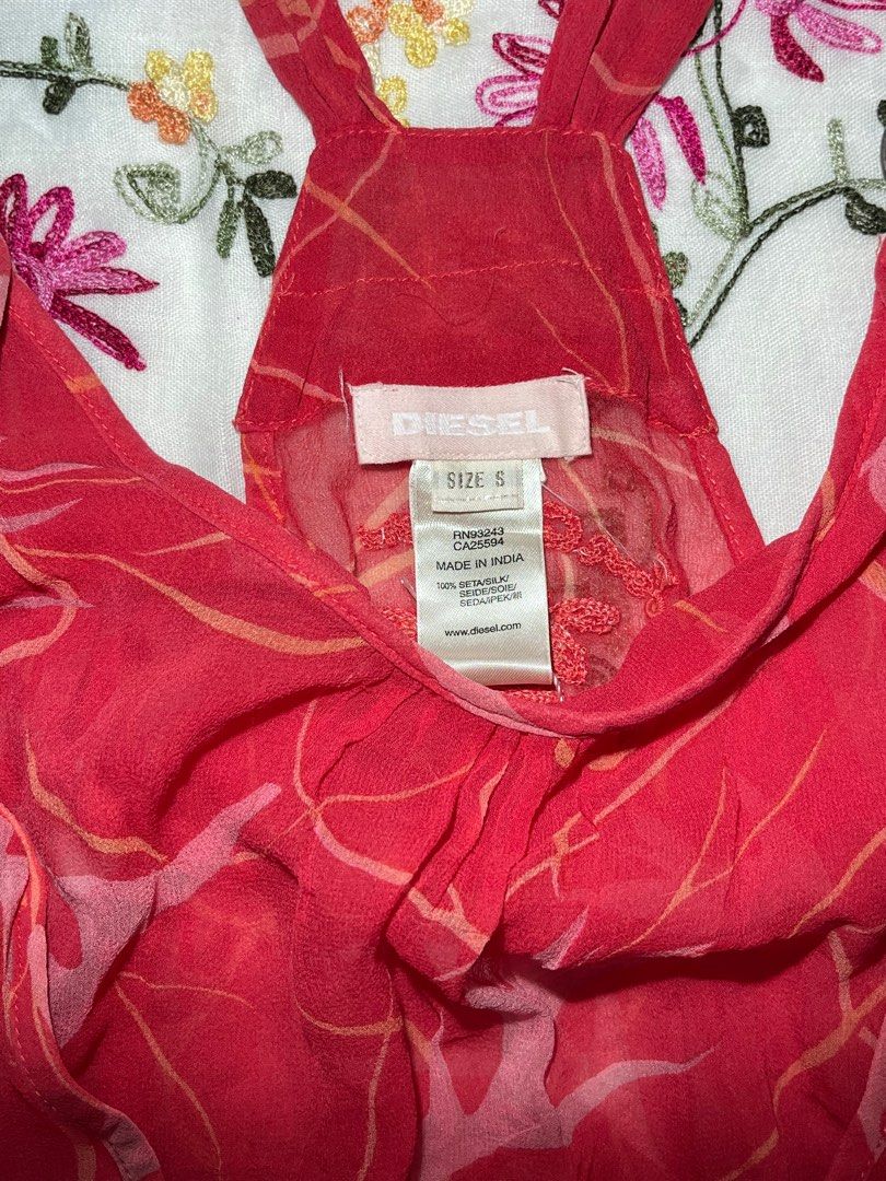 Diesel Red Tank Top Size S (Category: Sleeveless) located in Davao. Submitted by sonateine (Listing ID 1407276615, Image 2). Description: - Red Diesel tank top - Size: S - Halter neck with ring details - Wrap-style front - Elasticated hem - Unique pattern - Made in India - Embroidered back.