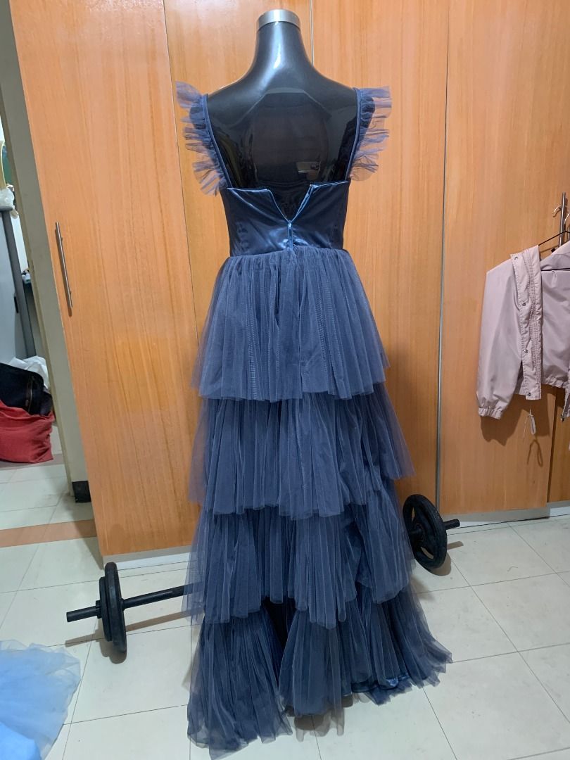 Dusty Blue Tiered Tulle Gown (Category: Evening dresses & gowns) located in Quezon City. Submitted by rafasamirgal (Listing ID 1407368485, Image 2). Description: - Elegant dusty blue gown - Floor-length design - Fitted bodice - Delicate ruffle strap details - Tiered tulle skirt - Back zipper closure - Perfect for formal events and special occasions.