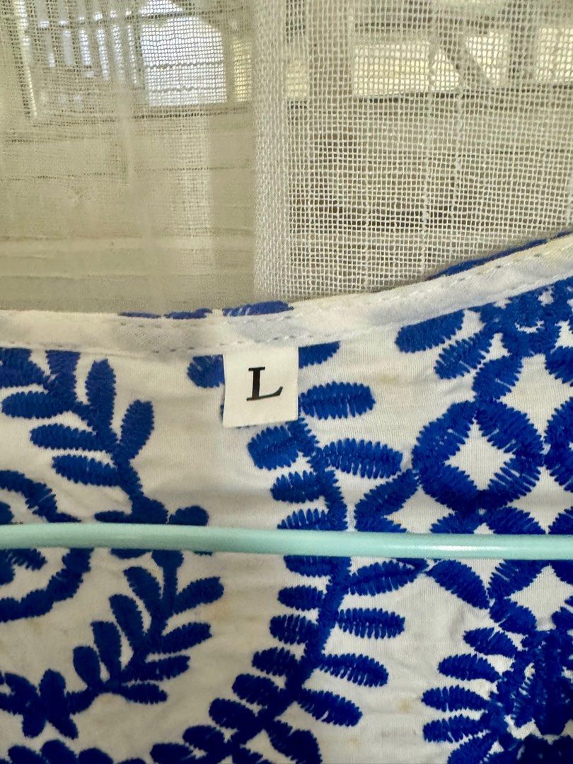 Embroidered Top - Blue and White - Size L (Category: Blouses) located in Angeles City. Submitted by mityi10s (Listing ID 1407205027, Image 2). Description: White embroidered top with royal‑blue floral pattern, size L (brandless). Brand new, detailed embroidery and scalloped hem—perfect for jeans, skirts, or summer outings. Selling for 499, negotiable..