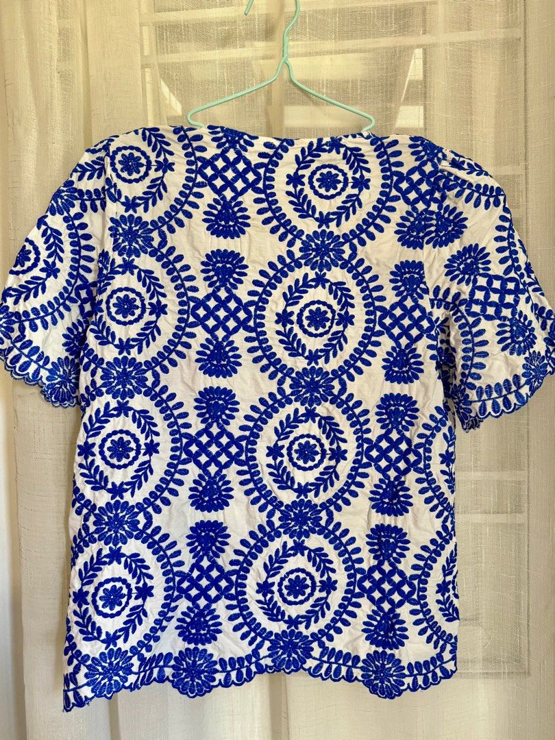 Embroidered Top - Blue and White - Size L (Category: Blouses) located in Angeles City. Submitted by mityi10s (Listing ID 1407205027, Image 3). Description: White embroidered top with royal‑blue floral pattern, size L (brandless). Brand new, detailed embroidery and scalloped hem—perfect for jeans, skirts, or summer outings. Selling for 499, negotiable..