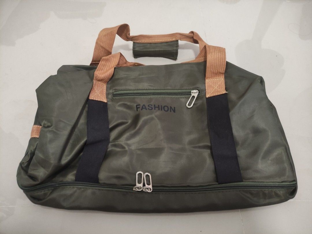 PRELOVED Fashion Duffle Bag with Multiple Compartments (Category: Sling Bags) located in Quezon City. Submitted by thetimelessfinds (Listing ID 1407279834, Image 3). Description: Selling my preloved duffle gym bag. The item was only used once for an out-of-town trip, then was never used again. The only issue is the seam in the shoe compartment that came undone. Other than that, the bag is still in good condition The item can be shipped, however, 
