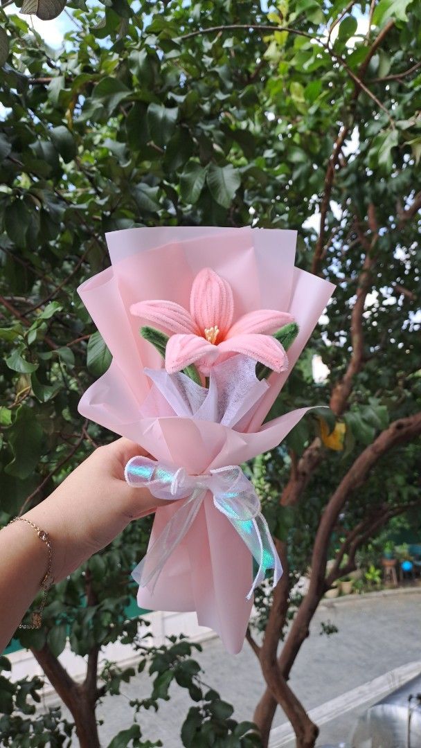 Handmade Crochet Lily Bouquet (Category: Flowers & Bouquets) located in Manila. Submitted by fluffiness52676 (Listing ID 1407313700, Image 1). Description: - Handmade crochet lily bouquet - Features a single pink lily flower - Wrapped in pink paper with a ribbon - Perfect for gifting - Ideal as a decorative piece - Unique and lovely item #flowerbouquet #giftideas #anniversarygifts #monthsarrygifts #fuzzyflowers #fuzzywireflower.