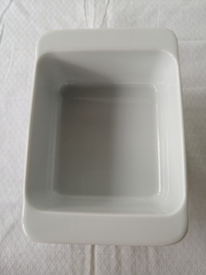 IKEA Square Baking Dishes (Category: Bakeware) located in Liloan. Submitted by aidolcapz88 (Listing ID 1407287836, Image 3). Description: - Set of two IKEA square baking dishes - White ceramic material - Modern and simple design - Slightly raised edges - Ideal for baking or serving small portions - Features IKEA logo and product information on the bottom.