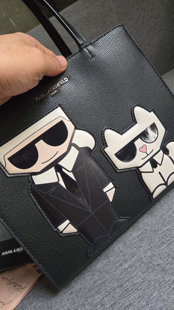 Karl Lagerfeld Black Tote Bag (Category: Tote Bags) located in Meycauayan. Submitted by tuschy (Listing ID 1407195239, Image 3). Description: - Black Karl Lagerfeld tote bag - Unique design - Top handle and detachable shoulder strap - Secure zip closure - Includes original box and tags - Features Karl Lagerfeld logo - Interior pocket - slightly used - with sign of usage. has minimal scratches -negotiable.