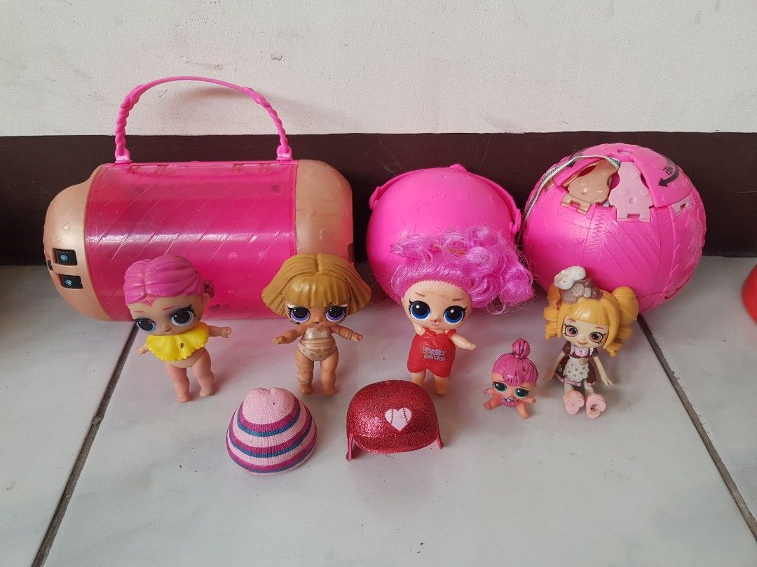 LOL Surprise Dolls with Accessories (Category: Kids Toys) located in Binangonan. Submitted by ms.vhi (Listing ID 1407298182, Image 3). Description: - LOL Surprise Doll Set take all - Includes dolls with various hair colors and styles - Comes with a pink carrying case - Includes multiple LOL Surprise balls - Features doll accessories like hats and outfits - Complete set as shown in the images.