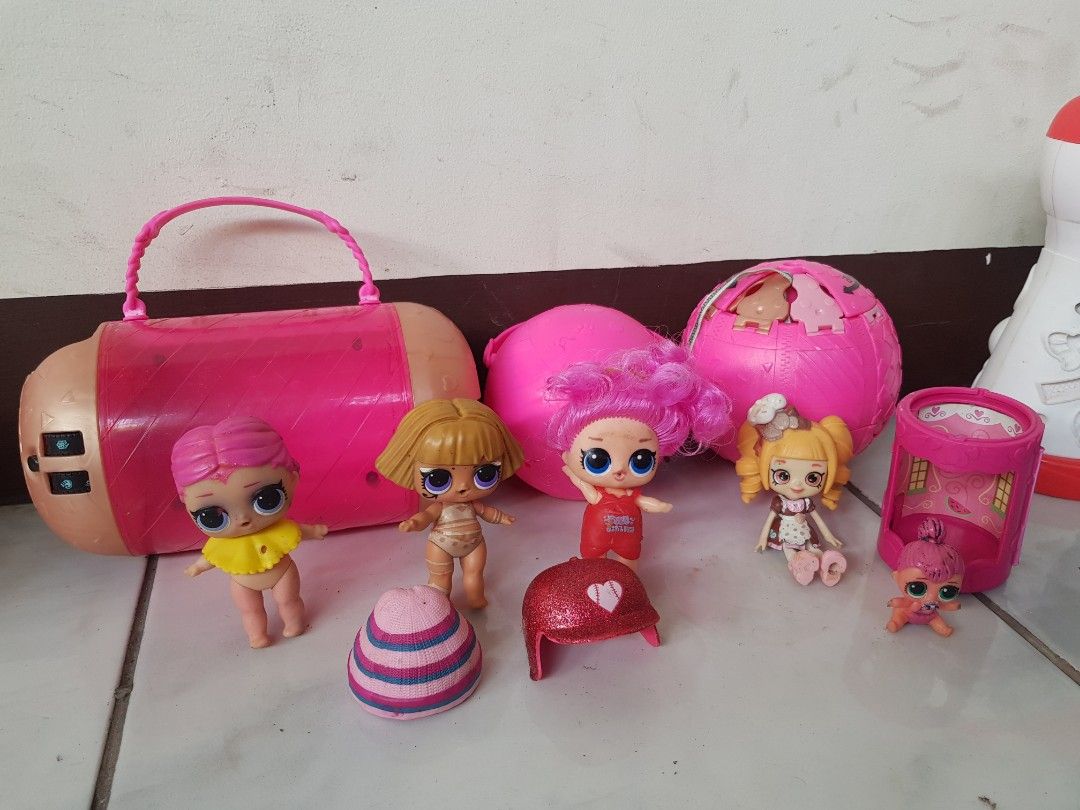LOL Surprise Dolls with Accessories (Category: Kids Toys) located in Binangonan. Submitted by ms.vhi (Listing ID 1407298182, Image 1). Description: - LOL Surprise Doll Set take all - Includes dolls with various hair colors and styles - Comes with a pink carrying case - Includes multiple LOL Surprise balls - Features doll accessories like hats and outfits - Complete set as shown in the images.