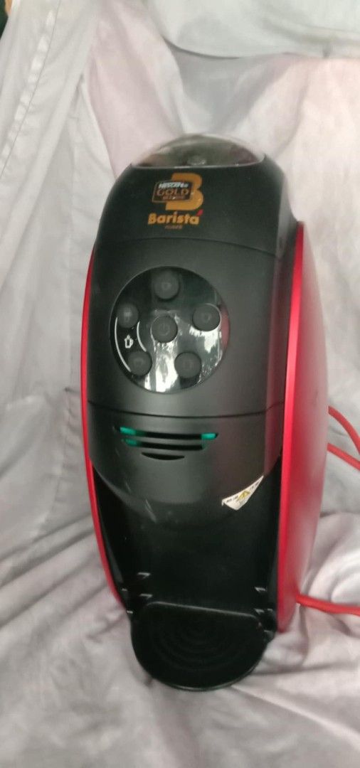 Nescafe Gold Blend Barista Coffee Machine (Category: Coffee Machines & Makers) located in Quezon City. Submitted by jpnvintageonline (Listing ID 1407200276, Image 1). Description: - Stylish Nescafe Gold Blend Barista coffee machine - Sleek black and red design - Includes a water reservoir - Features multiple coffee settings - Comes with a power cord - Includes a drip tray - Compact and easy to use.