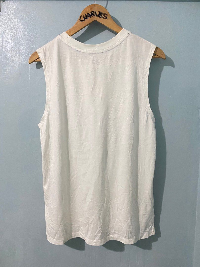 Nike Air Graphic Tank Top - White (Category: Sleeveless) located in Cabanatuan. Submitted by chingweyyy (Listing ID 1407306520, Image 3). Description: - White Nike tank top - Unique graphic design - Features Nike logo and "AIR" in playful font - Sleeveless with round neckline - Size: M - Made in China - Style: SU161203NIG - Code: 728468-100.