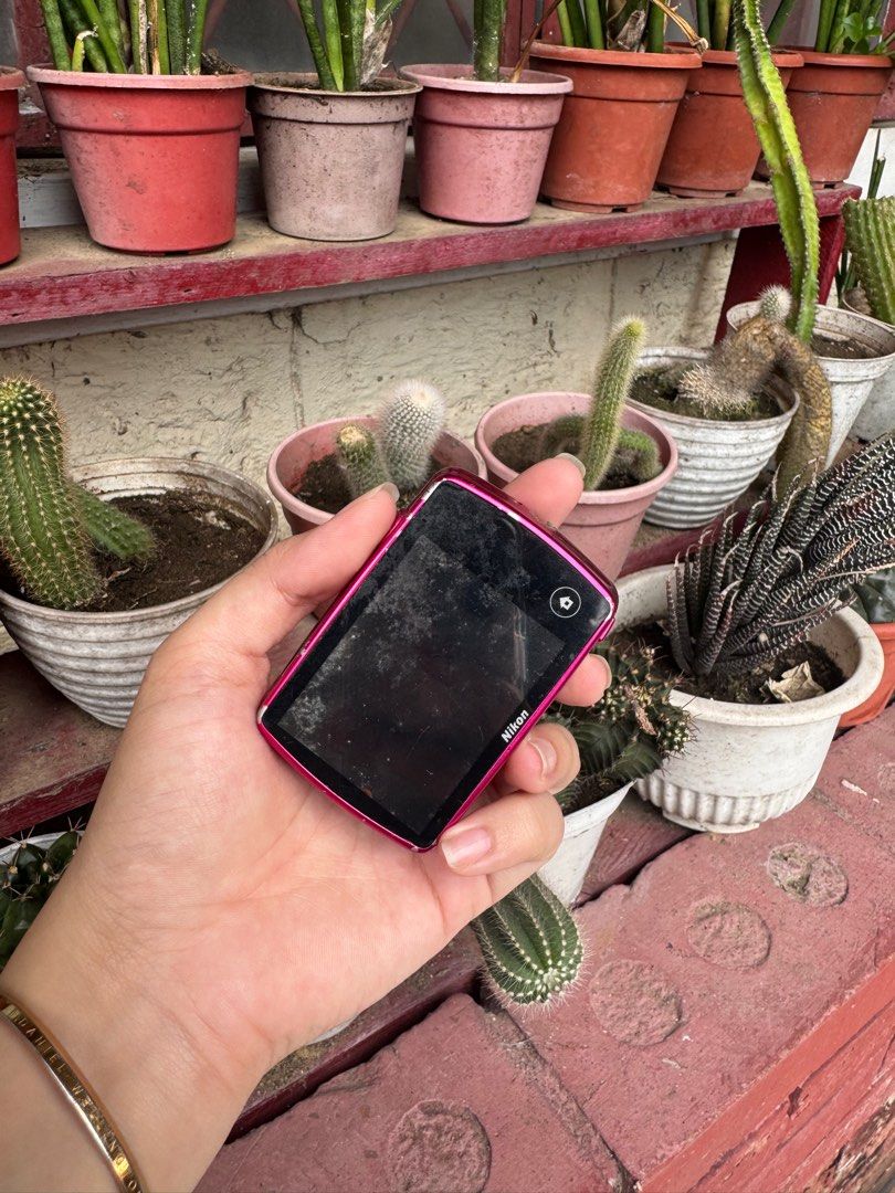 Nikon COOLPIX s01 digi cam pink (Category: Cameras) located in Las Pinas. Submitted by parungaoo (Listing ID 1407224438, Image 3). Description: - Pink Nikon COOLPIX digital camera - Features a lens and screen - Shows some signs of wear and tear - Includes a flash and lens cover - Power button and other controls located on top -still negotiable.