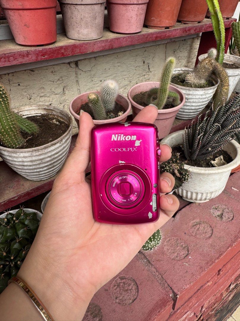 Nikon COOLPIX s01 digi cam pink (Category: Cameras) located in Las Pinas. Submitted by parungaoo (Listing ID 1407224438, Image 1). Description: - Pink Nikon COOLPIX digital camera - Features a lens and screen - Shows some signs of wear and tear - Includes a flash and lens cover - Power button and other controls located on top -still negotiable.