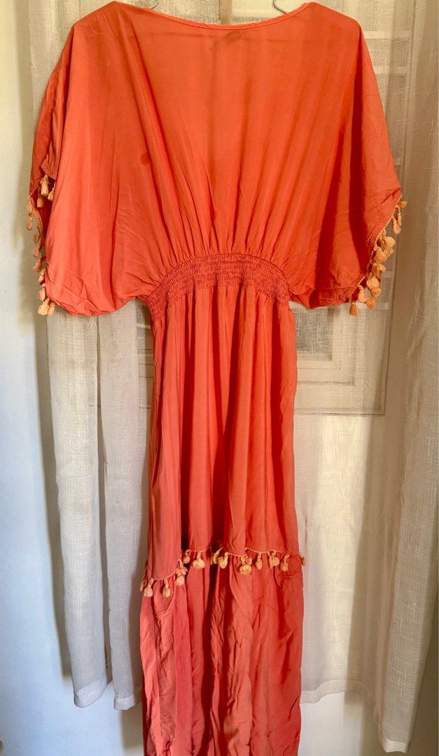Rusttydustty Coral Maxi Dress (Category: Dresses) located in Angeles City. Submitted by mityi10s (Listing ID 1407341330, Image 2). Description: - Rusttydustty coral maxi dress - Size: M - Features: - V-neckline - Elasticated waist - Short sleeves with tassel detailing - Tiered skirt with tassel accents Letting go for 349, negotiable.