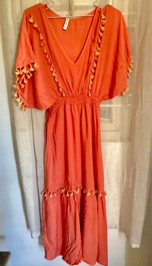 Rusttydustty Coral Maxi Dress (Category: Dresses) located in Angeles City. Submitted by mityi10s (Listing ID 1407341330, Image 1). Description: - Rusttydustty coral maxi dress - Size: M - Features: - V-neckline - Elasticated waist - Short sleeves with tassel detailing - Tiered skirt with tassel accents Letting go for 349, negotiable.