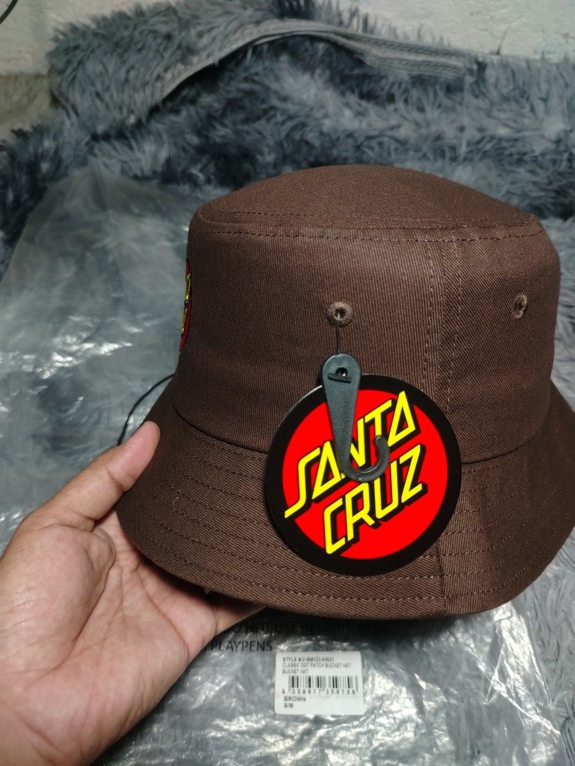 Santa Cruz Bucket Hat S/M (Category: Hats & Beanies) located in Rizal. Submitted by gmpastoffi75031 (Listing ID 1407325583, Image 2). Description: - Authentic Santa Cruz bucket hat - Color: Brown - Size: S/M - Material: 100% cotton - Features Santa Cruz logo - Includes original tags - Care: Hand wash only.